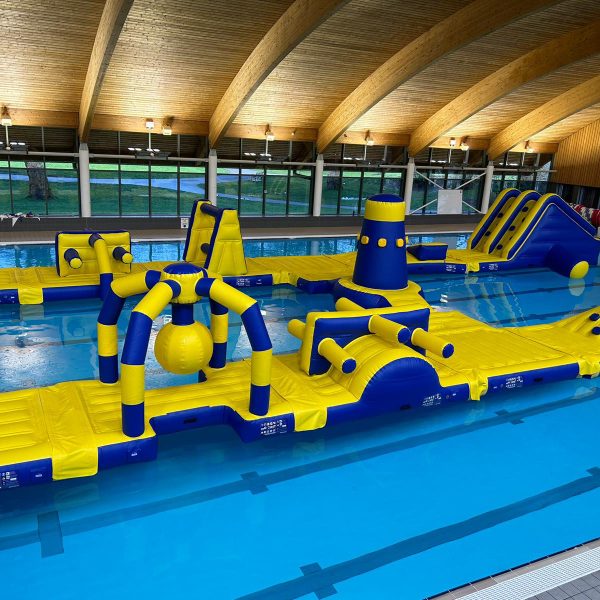 A picture of an Atlantis two lane aqua park in a swimming pool with beautiful wooden ceiling