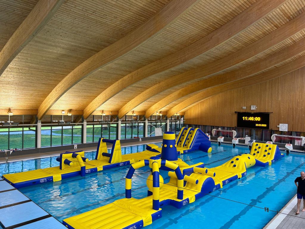 A picture of an Atlantis two lane aqua park in a swimming pool with beautiful wooden ceiling